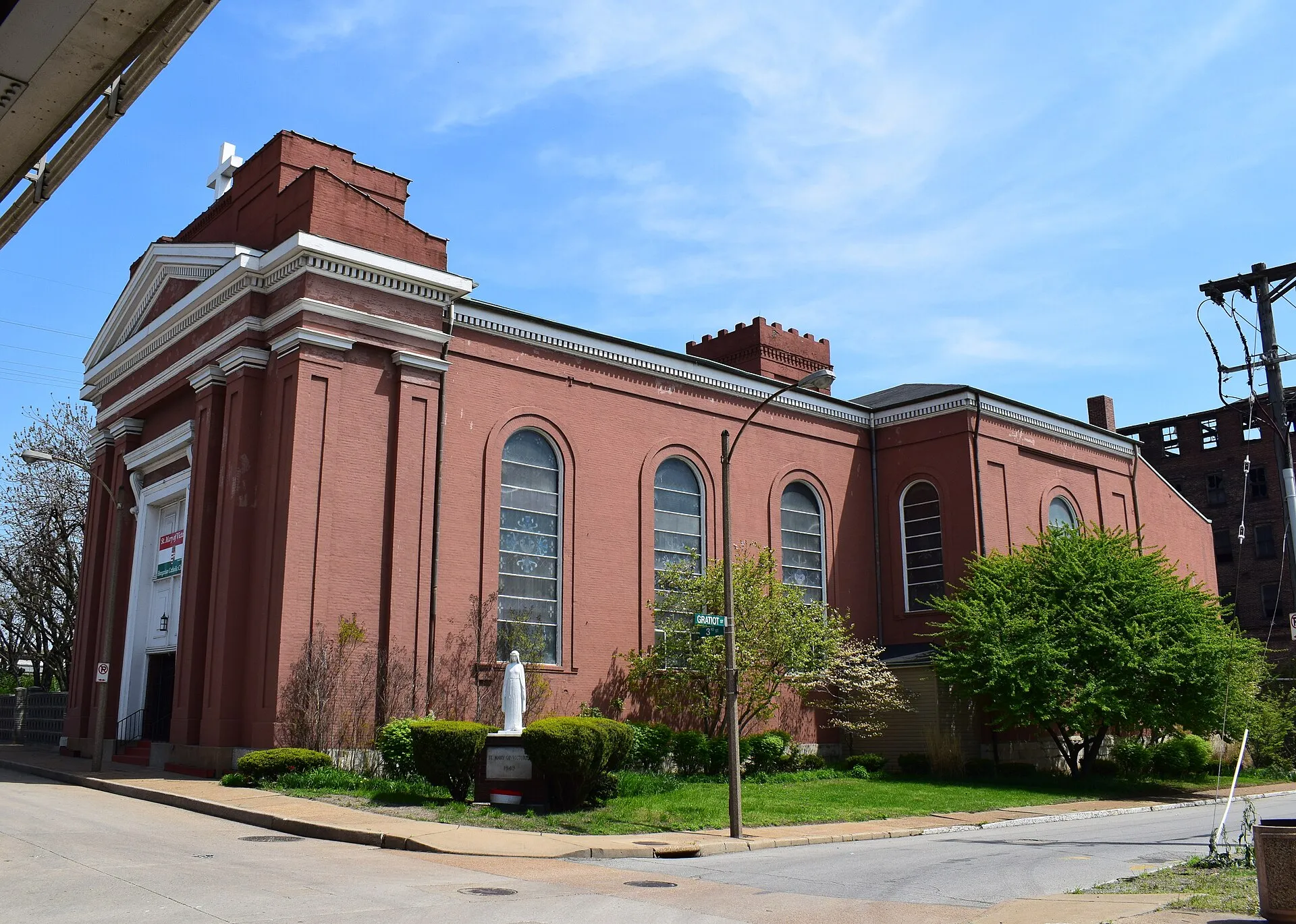 Exterior of Saint Mary of Victories Catholic Church in St. Louis, red brick with arched windows